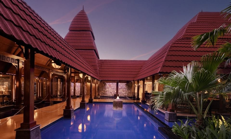 Courtyard pool beautifully lit at night at Ananta Spa & Resort Pushkar, creating a magical setting for evening wedding receptions in Rajasthan
