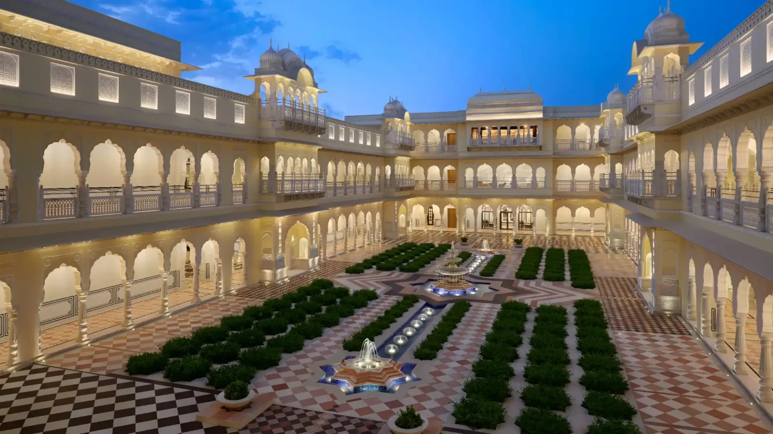 Central courtyard with fountains and Rajasthani arches at dusk at Hyatt Regency Jaipur Mansarovar
