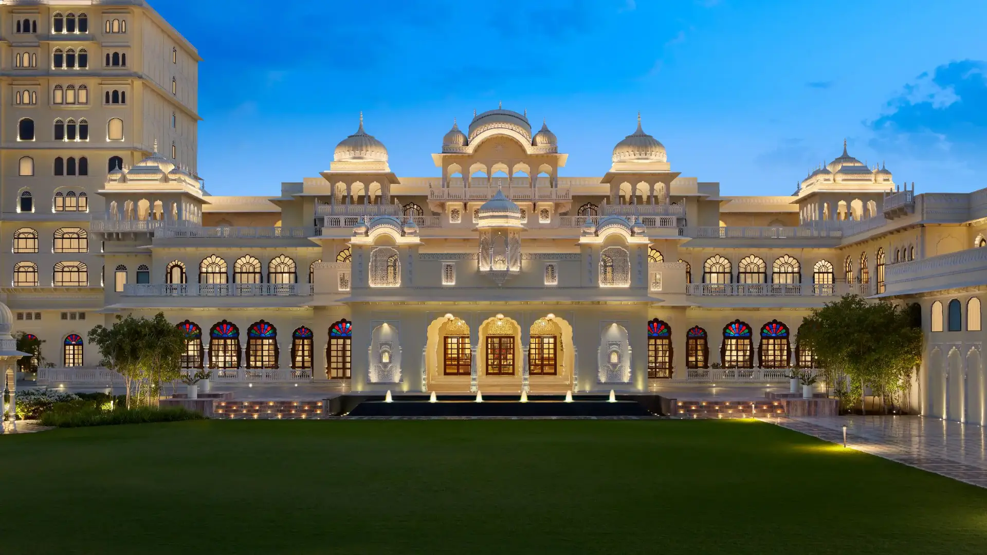 Illuminated palace-style facade with domes at dusk at Hyatt Regency Jaipur Mansarovar