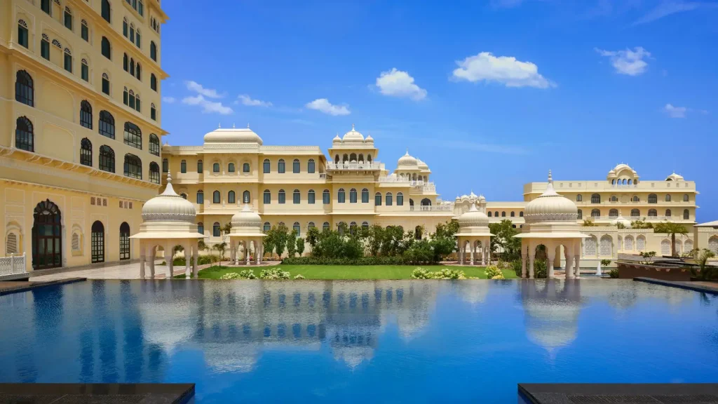 Palace-style facade of Hyatt Regency Jaipur Mansarovar reflected in the pool, a stunning destination wedding venue in Rajasthan