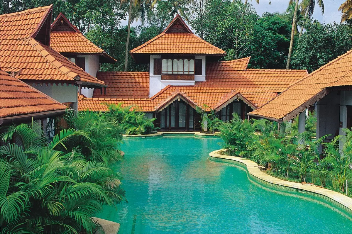 Meandering pool villas with red-tiled roofs at Kumarakom Lake Resort