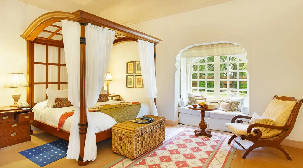 Premier Room with four-poster bed and window seat at The Oberoi Rajvilas, Jaipur