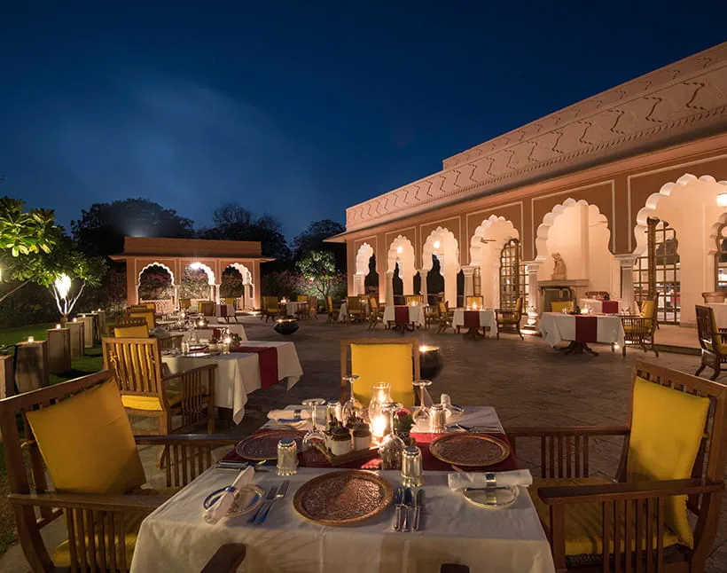 Raj Mahal restaurant courtyard dining at night at The Oberoi Rajvilas, Jaipur