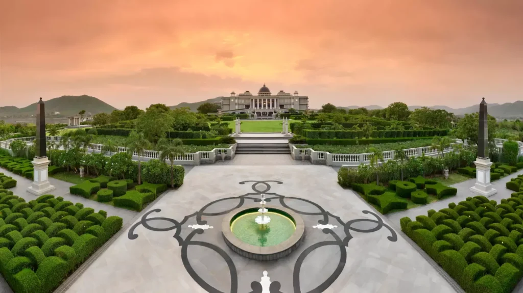 Formal garden and fountain leading to the palace facade at sunset at Raffles Udaipur