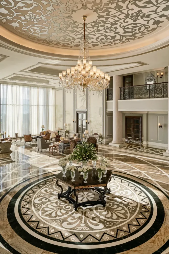 Grand lobby with inlaid marble floor and crystal chandelier at Raffles Udaipur