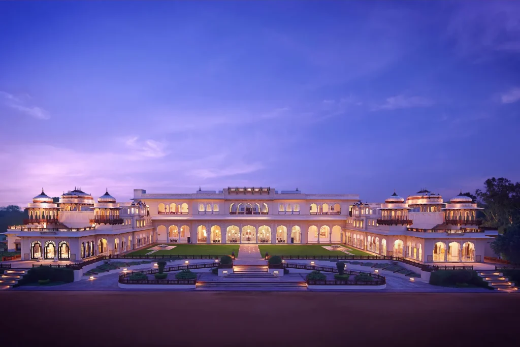 Rambagh Palace's Rajput-style facade illuminated at twilight, Jaipur