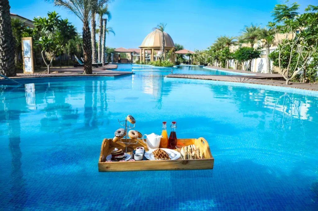 Romantic floating breakfast setup for newlyweds at The Westin Resort & Spa Pushkar, a unique honeymoon and post-wedding experience in Rajasthan