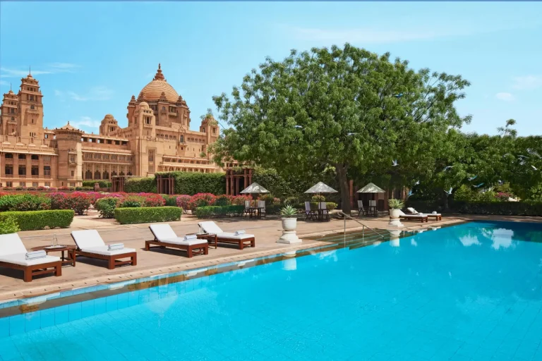 Magnificent swimming pool at Umaid Bhawan Palace Jodhpur with the grand palace dome in the background, one of India's most iconic royal wedding venues
