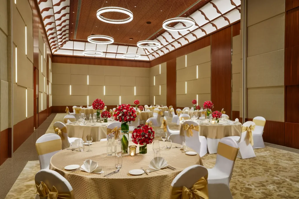 Round-table wedding banquet setup with gold décor at Taj Wayanad Resort & Spa