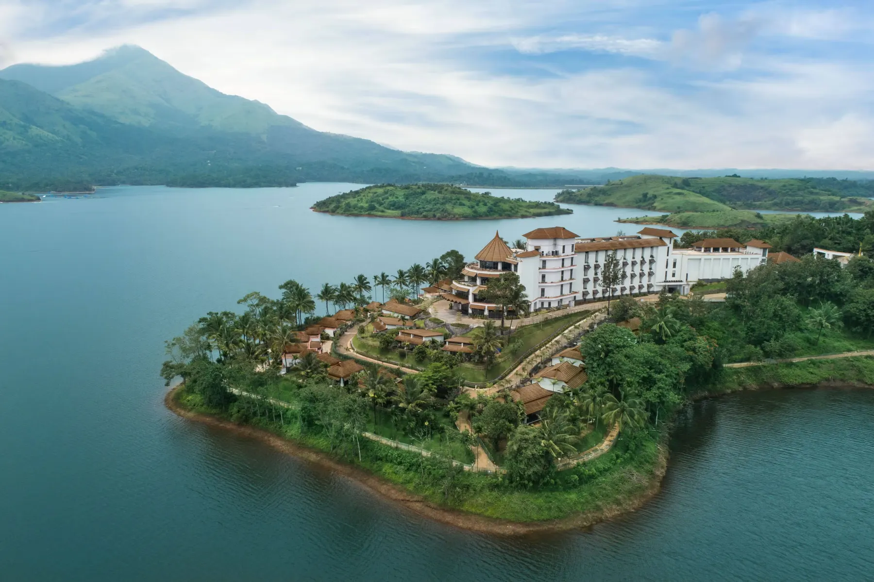 Aerial view of Taj Wayanad Resort & Spa peninsula on Banasura Lake surrounded by hills