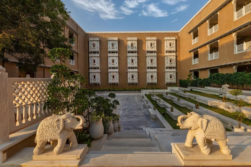 Courtyard with carved jharokha windows and stone elephants at Wyndham Grand Udaipur Fatehsagar Lake