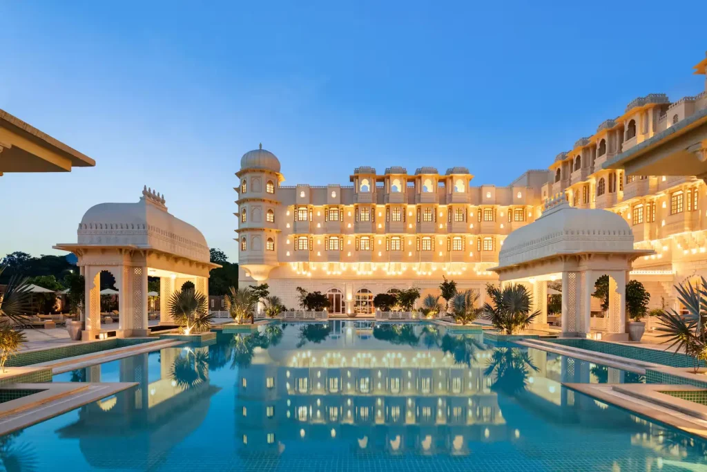 Palace-inspired facade reflected in pool at dusk at Wyndham Grand Udaipur Fatehsagar Lake