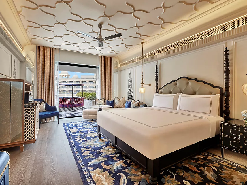 Luxury room with four-poster bed ornate ceiling and balcony at Fairmont Udaipur Palace