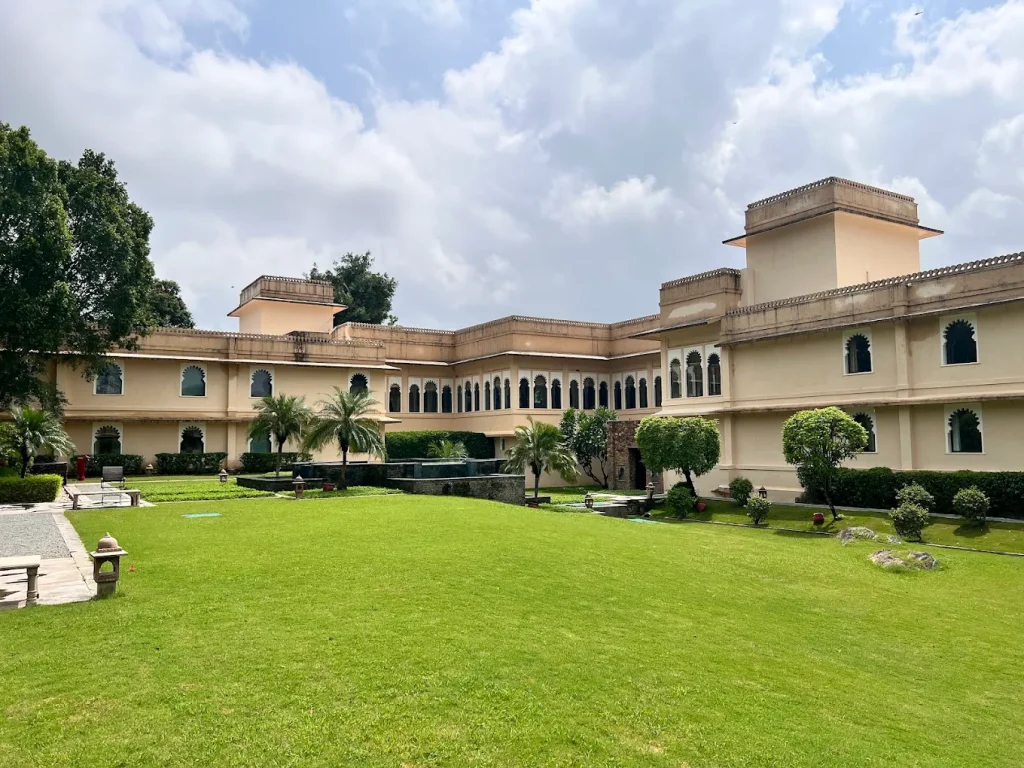 Expansive manicured lawn facing heritage Mewar-style garden wing at Trident Udaipur