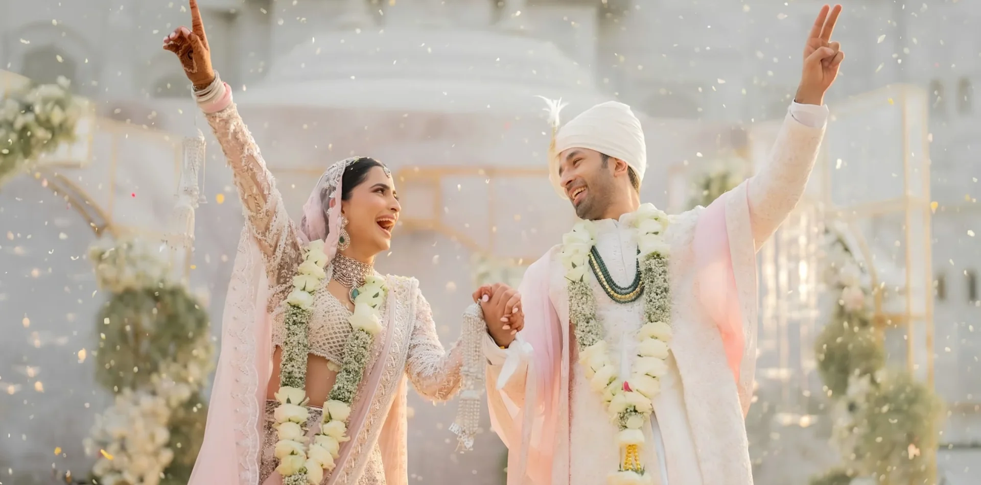Destination wedding planner in Udaipur: happy bride and groom celebrating with flower petals at a Desert Pearl wedding