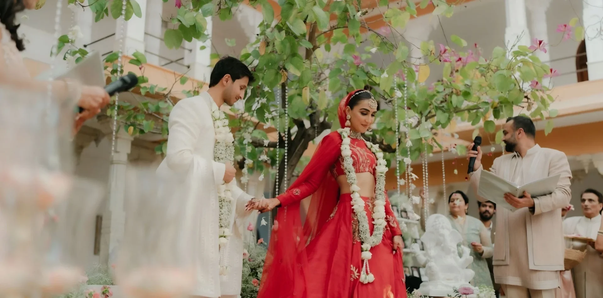 Luxury wedding planner in Udaipur: bride and groom at a Hindu wedding ceremony in a floral courtyard