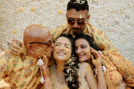Bride and family sharing an emotional group portrait during the Haldi ceremony at a luxury destination wedding in Jaipur by Desert Pearl Weddings