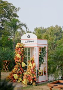 Floral telephone booth as unique wedding décor at a destination wedding in Udaipur, an imaginative and Instagram-worthy installation by Desert Pearl Weddings