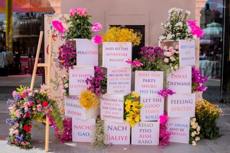 Floral wedding sign wall with funny Hindi and English quotes at Mehendi ceremony Fairmont Jaipur