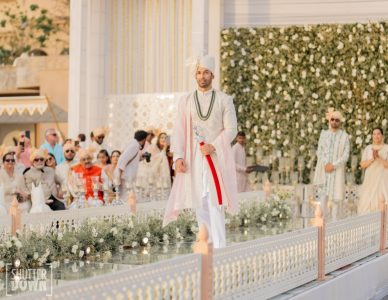 Groom making a dramatic entry with a ceremonial sword at his Fairmont Jaipur destination wedding, capturing the royal spirit of a traditional Rajasthani wedding