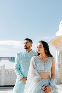Couple in matching powder blue outfits sharing a tender portrait at their palace Mehendi ceremony in Jaipur, photographed for Desert Pearl Weddings