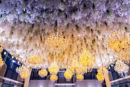 White floral ceiling installation with gold crystal chandeliers at Fairmont Jaipur reception hall