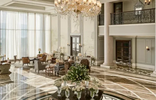 Grand lobby with inlaid marble floor and crystal chandelier at Raffles Udaipur