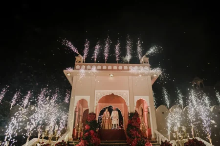 Creative shadow portrait of bride in teal cape lehenga with groom's blurred silhouette at mehendi night, destination wedding in Rajasthan by Desert Pearl Weddings