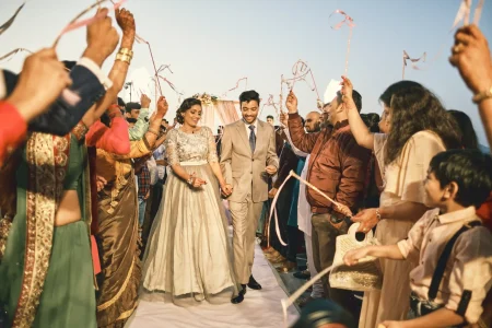 Couple sharing an intimate golden hour moment during engagement ceremony with Aravalli hills in backdrop at rooftop destination wedding venue in Rajasthan
